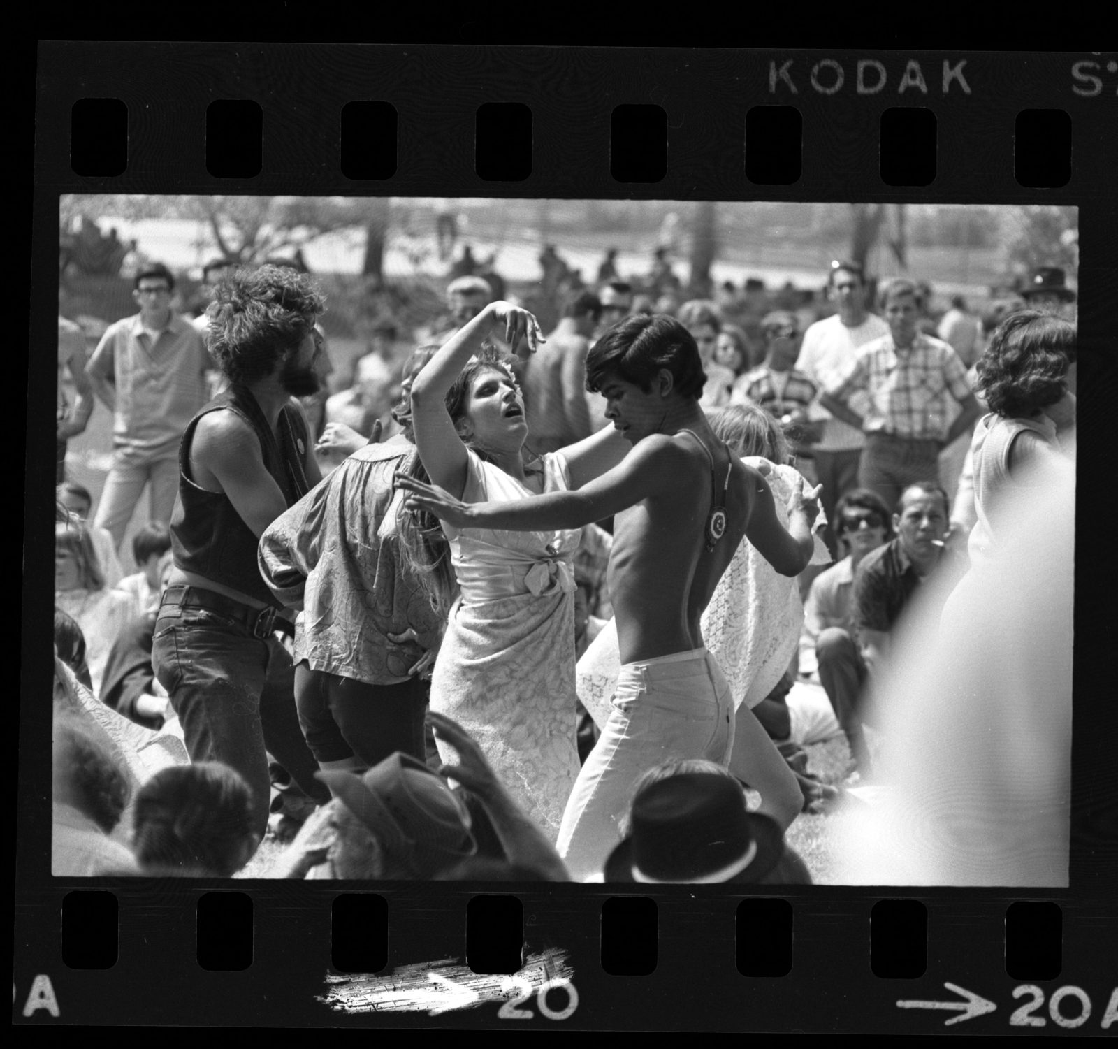 Couples dancing in the crowd at love-in held at Griffith Park, Los Angeles, 1967