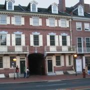 A brick row on a Philadelphia street with an arched carriageway